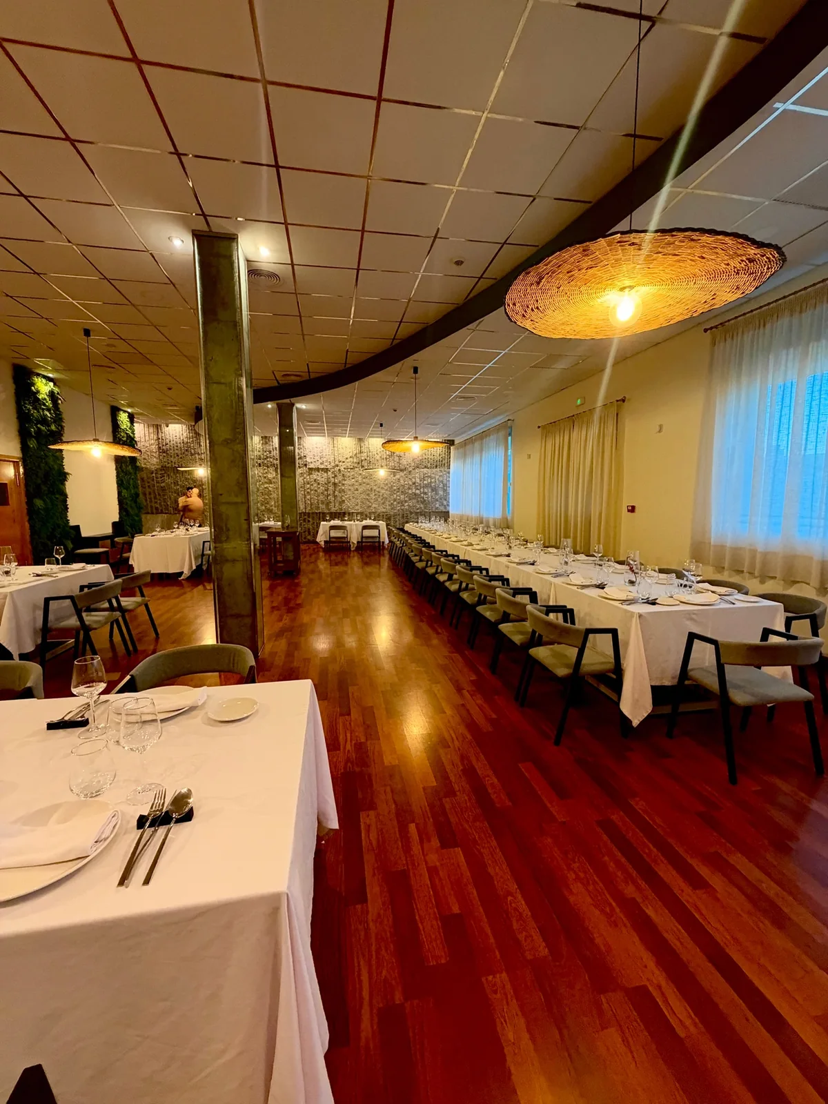 Somnium’s dining room, with laid tables and warm lighting